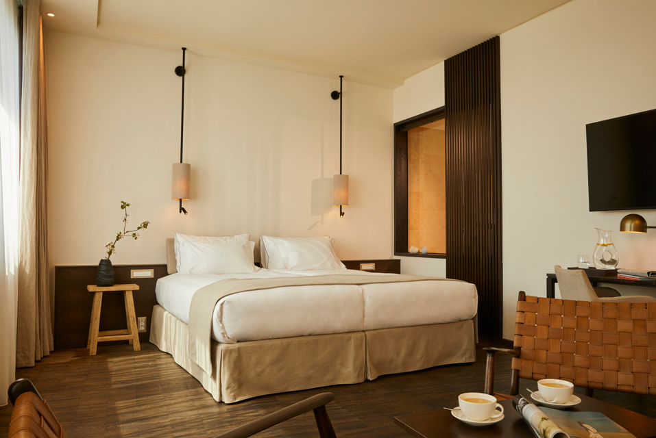 Zimmer im INFINITY Hotel mit Doppelbett und Sitzbereich